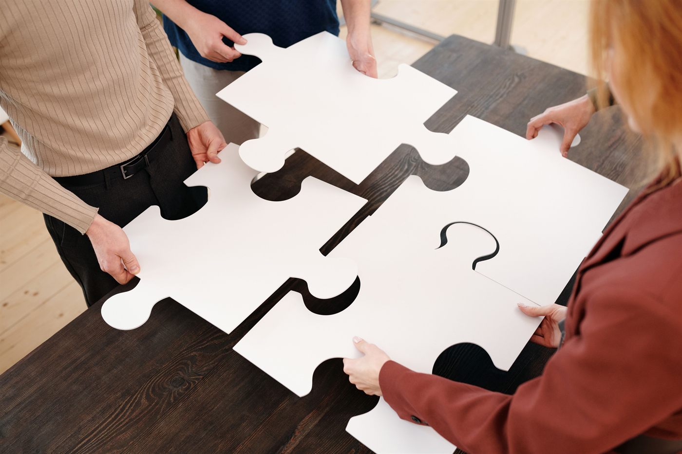 Team assembling a puzzle together